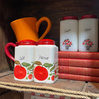Vintage white salt and pepper shakers with red lids