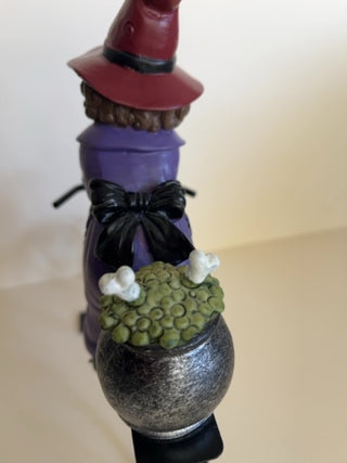 Cute Witch Riding a Metal Bike with Cauldron