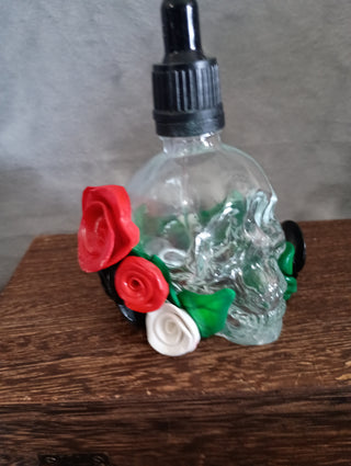 Glass skull bottle with polymer clay foliage (red)