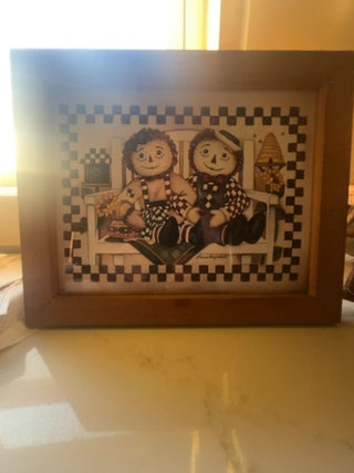 Raggedy Ann and Andy sitting on a bench, song by  Laurie Korsgaden.