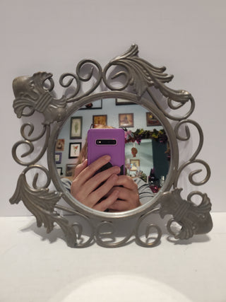 Metal framed mirror fleur-de-lis design