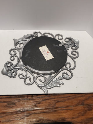 Metal framed mirror fleur-de-lis design