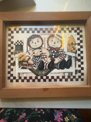 Raggedy Ann and Andy sitting on a bench, song by  Laurie Korsgaden.