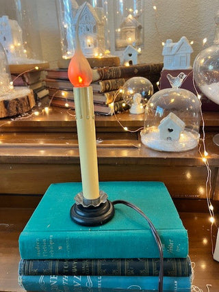 Antique candlestick with flickering lightbulb.