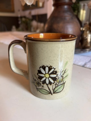 JP vintage 1970s speckled stoneware coffee mug with a white daisy