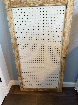 Large  repurposed barn screen door made into a pegboard