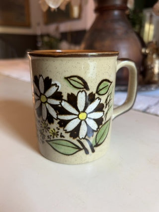 JP vintage 1970s speckled stoneware coffee mug with a white daisy