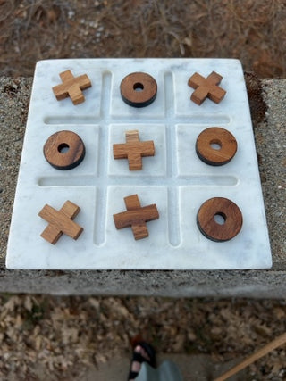 Tic-Tac-Toe set features a white marble base & wood playing pieces