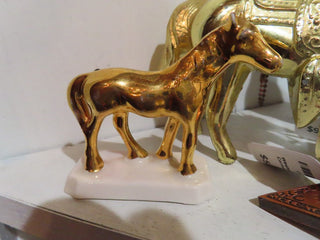 small brass horse on white stand RCD