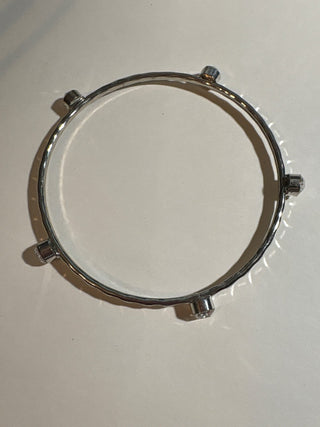 silver colored bangle with clear stones