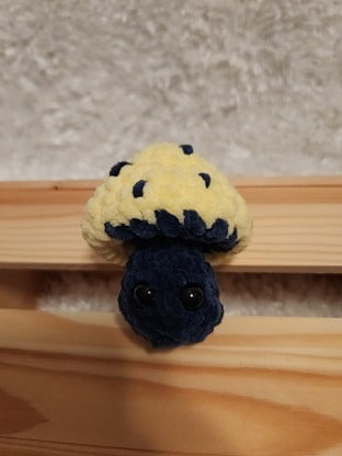 Mushroom Fidget Popper: Crocheted yellow, navy. Fidget pops in and out.