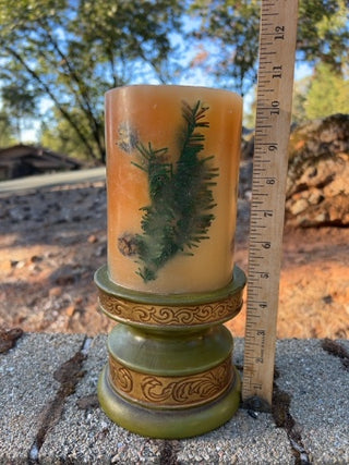 JP Pier One decorative botanical pillar candle featuring embedded olive-green pedestal holder