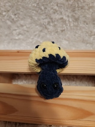 Mushroom Fidget Popper: Crocheted yellow, navy. Fidget pops in and out.