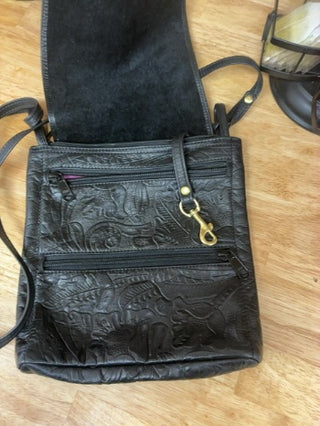 "Michelle Barclay Boutique Designer Crossbody Bag. Genuine thick tooled black leather with signature purple suede interior lining. Excellent condition!"