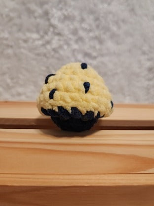 Mushroom Fidget Popper: Crocheted yellow, navy. Fidget pops in and out.
