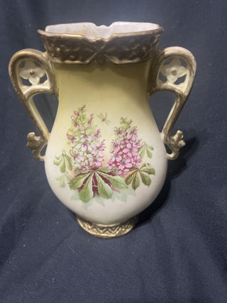 Cream colored vase with flowers and gold handles rsv