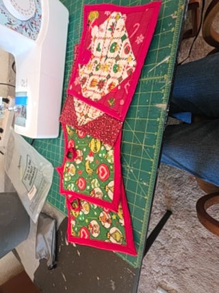 Various quilted Christmas potholders,  all lined with Wrap N Zap