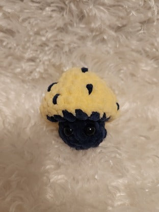 Mushroom Fidget Popper: Crocheted yellow, navy. Fidget pops in and out.