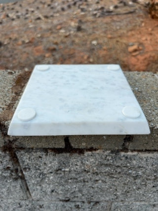 Tic-Tac-Toe set features a white marble base & wood playing pieces