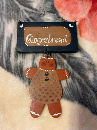 KW wooden sign painted with the word "Gingerbread" wooden gingerbread figure