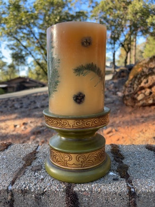 JP Pier One decorative botanical pillar candle featuring embedded olive-green pedestal holder