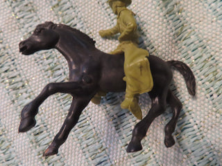 black horse and green cowboy