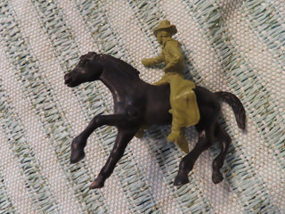 black horse and green cowboy