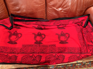 Swahili african cotton garment the phrase "Let them boil /fight over there ; with m you will cool down or peace"