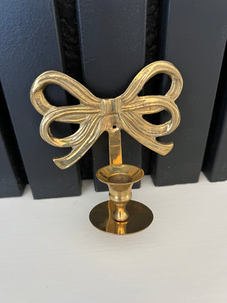 Brass bow candle sconce