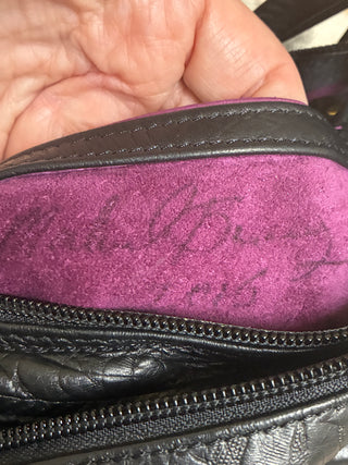 "Michelle Barclay Boutique Designer Crossbody Bag. Genuine thick tooled black leather with signature purple suede interior lining. Excellent condition!"