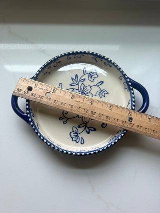 Temp-tations by Tara Floral Lace soup crock in Cobalt Blue, featuring a delicate white floral pattern and a bead-textured rim.Design: Cobalt blue ceramic with a white floral lace pattern and handle accents.Material: Constructed from durable ceramic design