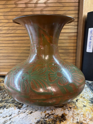 Metal copper colored vase with floral pattern