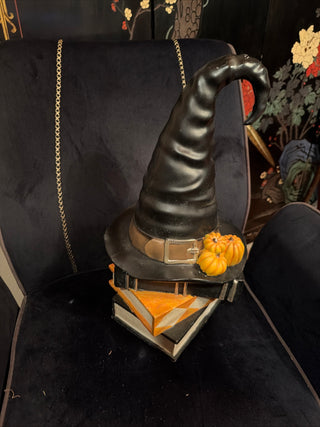 Halloween Black Witch Hat with Pumpkins on Stacked books