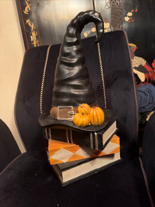 Halloween Black Witch Hat with Pumpkins on Stacked books