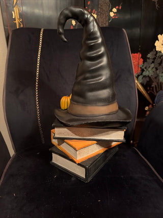 Halloween Black Witch Hat with Pumpkins on Stacked books