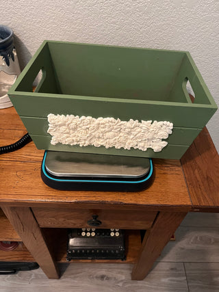 Green box with decoration on front