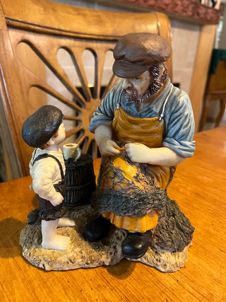 Sailor Mending A Fishnet With a Boy Collectable