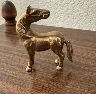 Vintage standing looking back brass horse