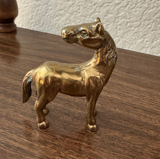 Vintage standing looking back brass horse
