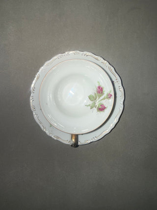 vintage three-footed "Moss Rose" porcelain teacup and saucer set