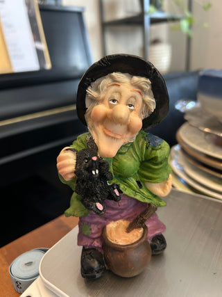 Witch In Green Shirt Holding Rat W/ Cauldron