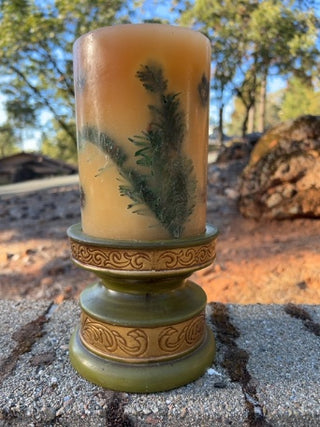 JP Pier One decorative botanical pillar candle featuring embedded olive-green pedestal holder