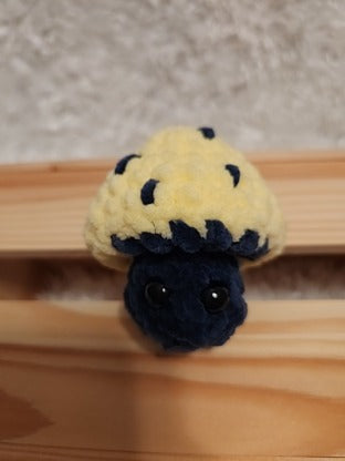 Mushroom Fidget Popper: Crocheted yellow, navy. Fidget pops in and out.