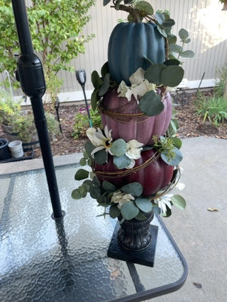 Three tiered pumpkin floral statue arrangement