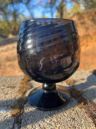 JP 5” amethyst art glass goblet with an optic swirl pattern and a short footed base