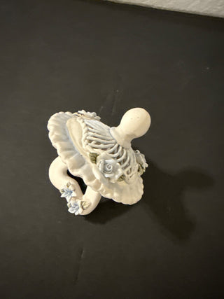 decorative collectible, specifically a Capodimonte porcelain baby pacifier.R CD