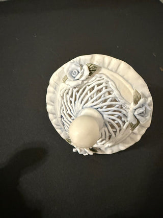 decorative collectible, specifically a Capodimonte porcelain baby pacifier.R CD