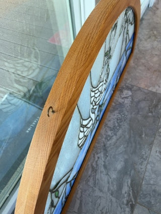 Stained glass window arch framed swans