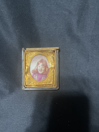 small gold frame with young girl with red hair rsv