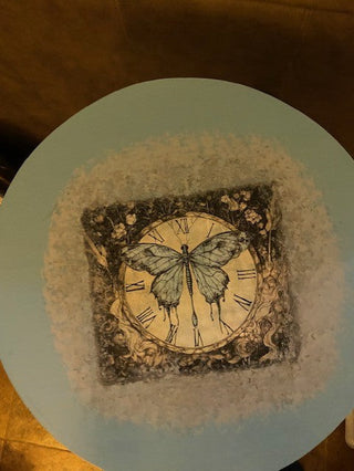 3 legged blue table with butterfly